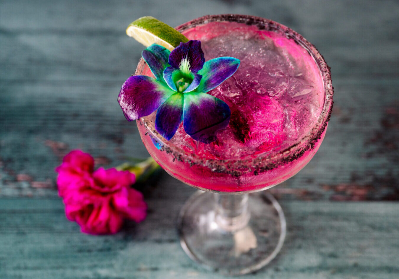 Pink drink with floral garnish